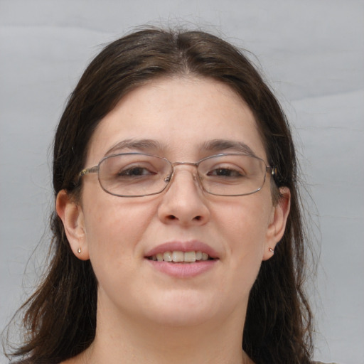 Joyful white adult female with long  brown hair and brown eyes