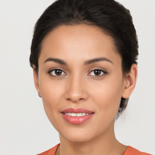 Joyful latino young-adult female with short  brown hair and brown eyes