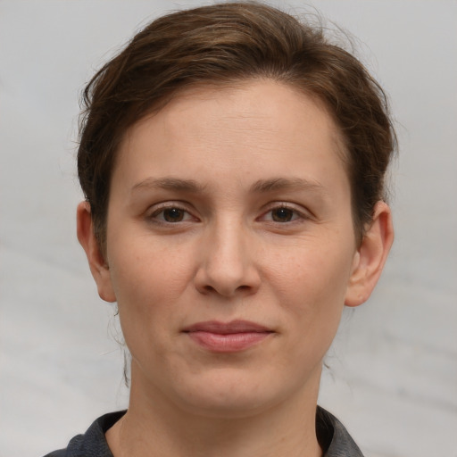 Joyful white adult female with short  brown hair and grey eyes