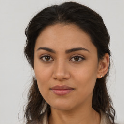 Joyful latino young-adult female with long  brown hair and brown eyes