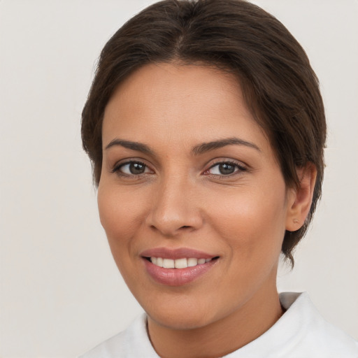 Joyful white young-adult female with short  brown hair and brown eyes