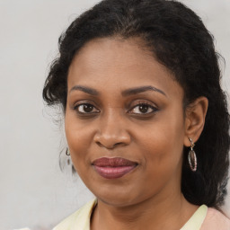 Joyful black young-adult female with medium  brown hair and brown eyes