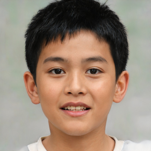 Joyful asian child male with short  brown hair and brown eyes