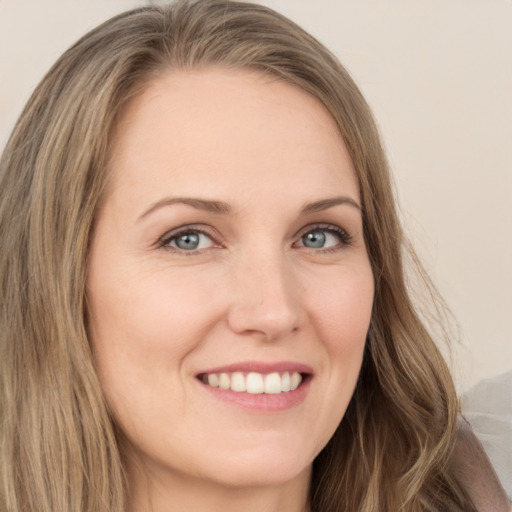 Joyful white young-adult female with long  brown hair and green eyes