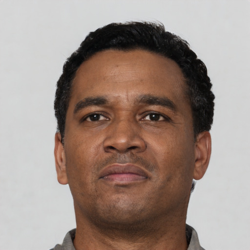 Neutral latino adult male with short  black hair and brown eyes