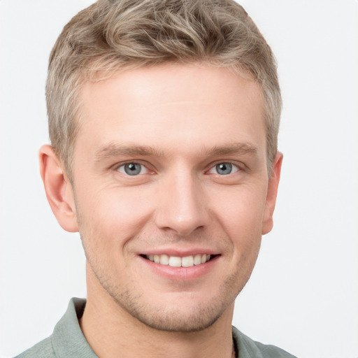 Joyful white young-adult male with short  brown hair and blue eyes