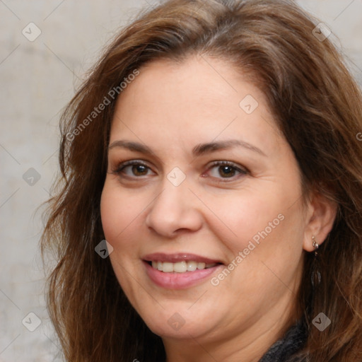 Joyful white adult female with long  brown hair and brown eyes