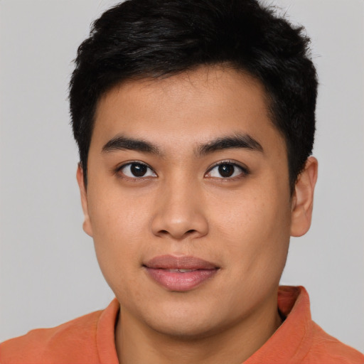 Joyful asian young-adult male with short  black hair and brown eyes