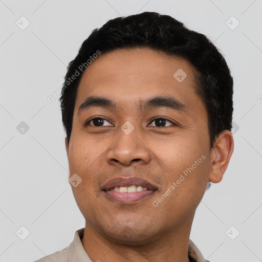 Joyful latino young-adult male with short  black hair and brown eyes