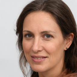 Joyful white adult female with long  brown hair and brown eyes