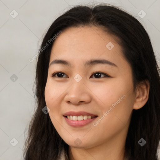 Joyful asian young-adult female with long  brown hair and brown eyes