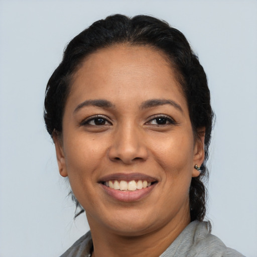 Joyful latino adult female with short  brown hair and brown eyes