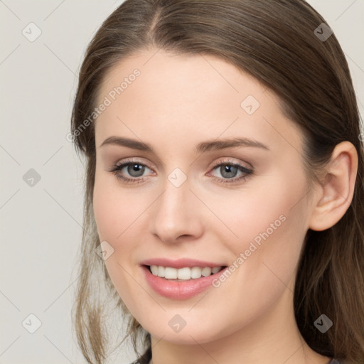 Joyful white young-adult female with long  brown hair and grey eyes