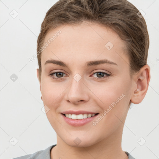 Joyful white young-adult female with short  brown hair and grey eyes