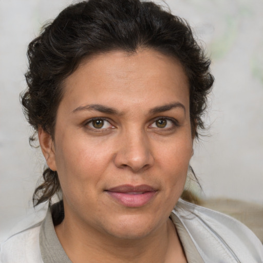 Joyful white adult female with medium  brown hair and brown eyes