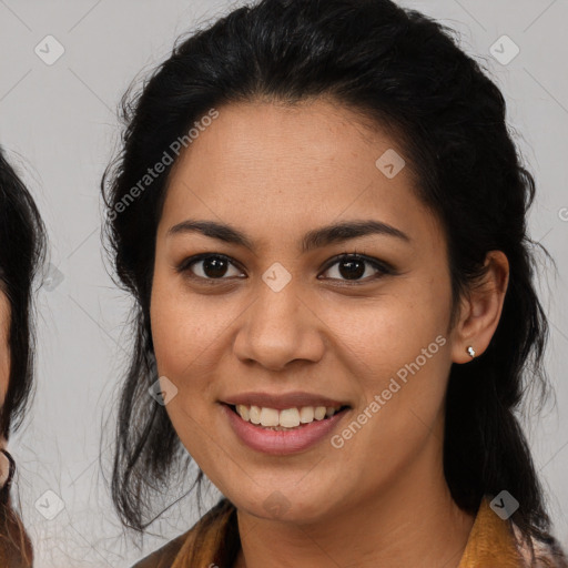 Joyful latino young-adult female with medium  brown hair and brown eyes