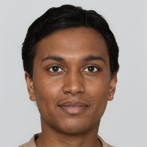 Joyful black young-adult male with short  brown hair and brown eyes