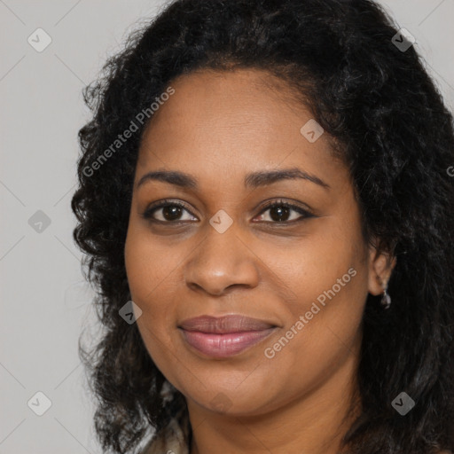 Joyful black young-adult female with long  brown hair and brown eyes