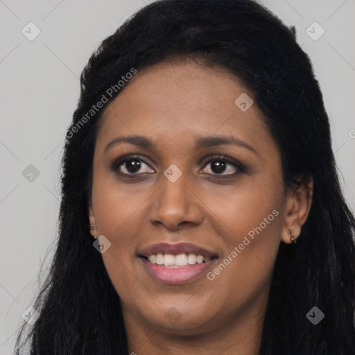 Joyful black young-adult female with long  black hair and brown eyes