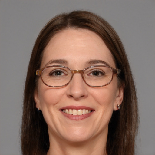 Joyful white adult female with long  brown hair and blue eyes