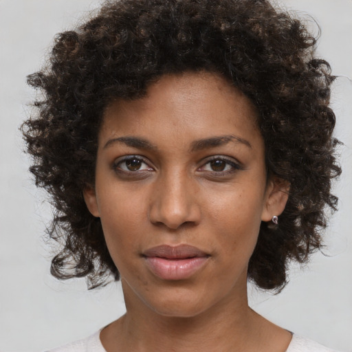 Neutral black young-adult female with medium  brown hair and brown eyes