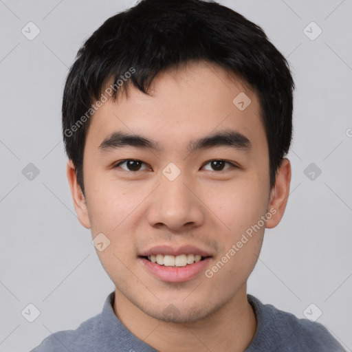 Joyful asian young-adult male with short  black hair and brown eyes