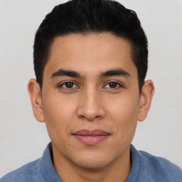 Joyful latino young-adult male with short  brown hair and brown eyes