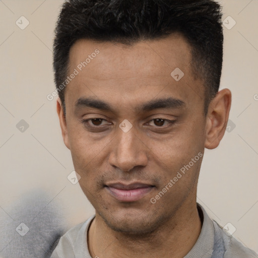 Joyful latino young-adult male with short  black hair and brown eyes