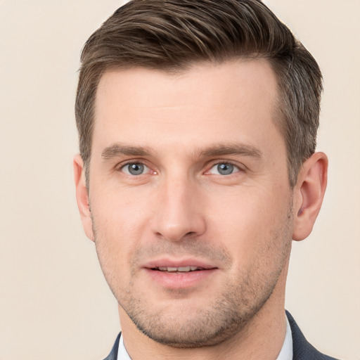 Joyful white young-adult male with short  brown hair and grey eyes