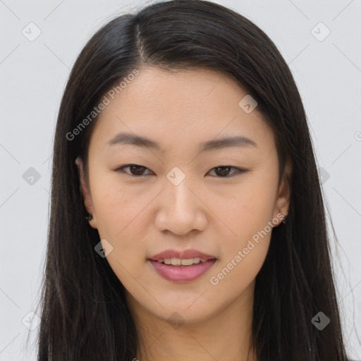 Joyful asian young-adult female with long  brown hair and brown eyes