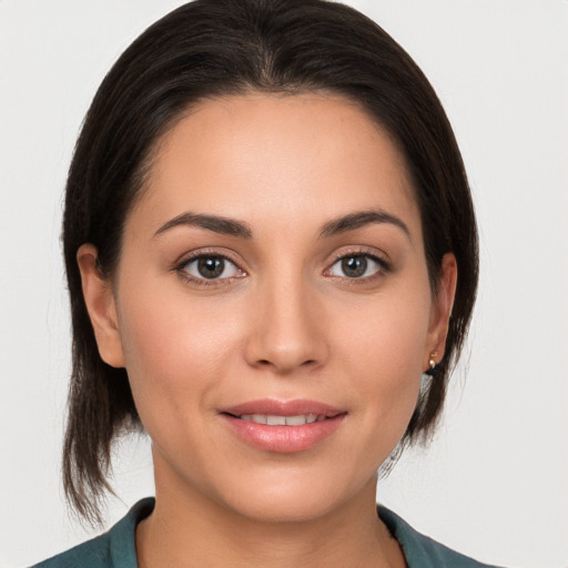 Joyful white young-adult female with medium  brown hair and brown eyes