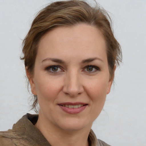 Joyful white adult female with medium  brown hair and grey eyes