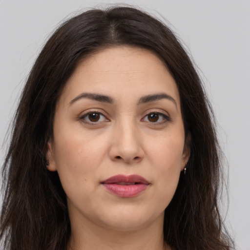 Joyful white young-adult female with long  brown hair and brown eyes