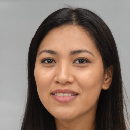 Joyful latino young-adult female with long  brown hair and brown eyes