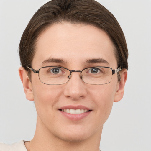 Joyful white young-adult female with short  brown hair and grey eyes