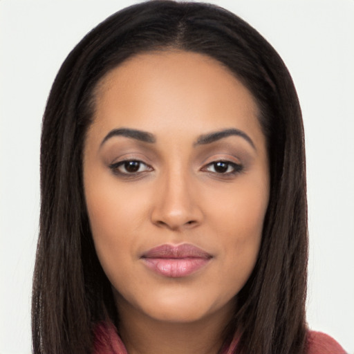 Joyful latino young-adult female with long  brown hair and brown eyes