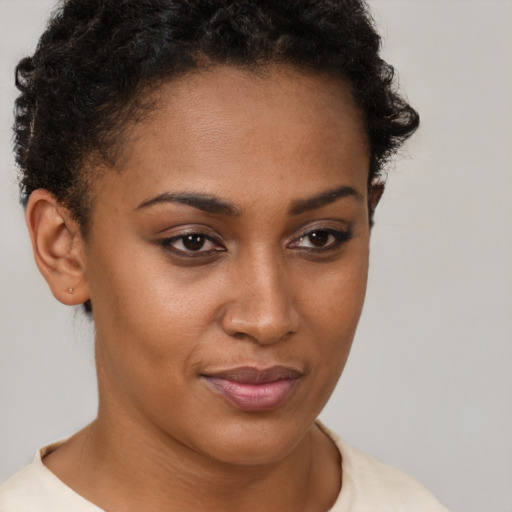 Joyful black young-adult female with short  brown hair and brown eyes