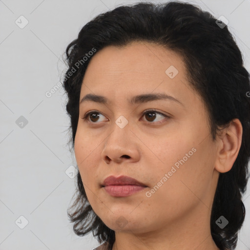 Joyful latino young-adult female with medium  black hair and brown eyes