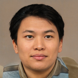 Joyful asian young-adult male with short  black hair and brown eyes