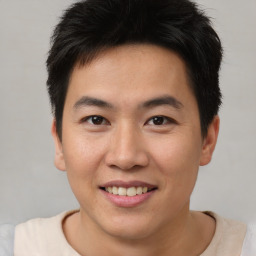 Joyful asian young-adult male with short  brown hair and brown eyes