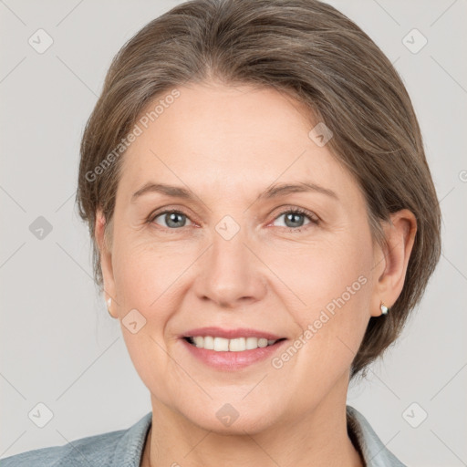 Joyful white adult female with medium  brown hair and grey eyes