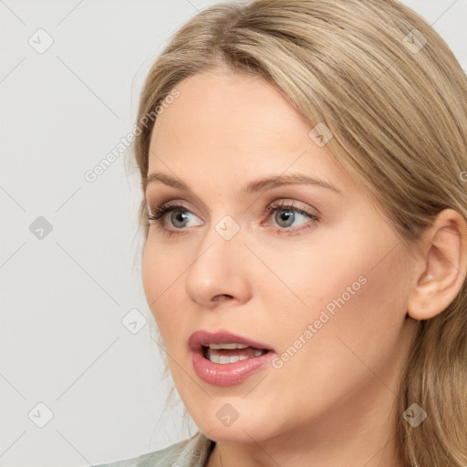 Joyful white young-adult female with long  brown hair and blue eyes