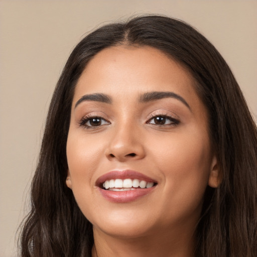 Joyful white young-adult female with long  brown hair and brown eyes