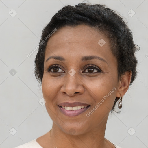 Joyful black adult female with short  brown hair and brown eyes