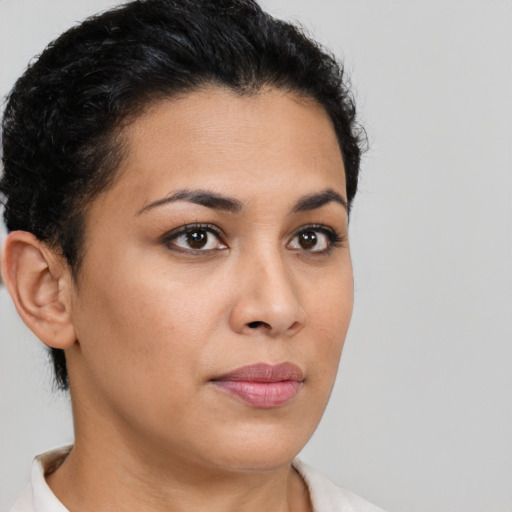 Joyful latino young-adult female with short  brown hair and brown eyes