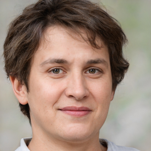 Joyful white adult male with medium  brown hair and brown eyes