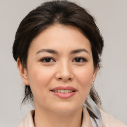 Joyful asian young-adult female with medium  brown hair and brown eyes