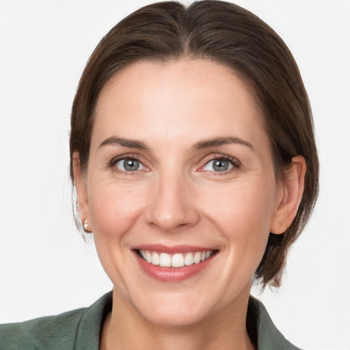 Joyful white adult female with medium  brown hair and grey eyes