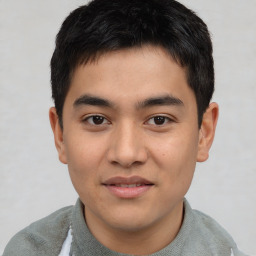 Joyful asian young-adult male with short  brown hair and brown eyes