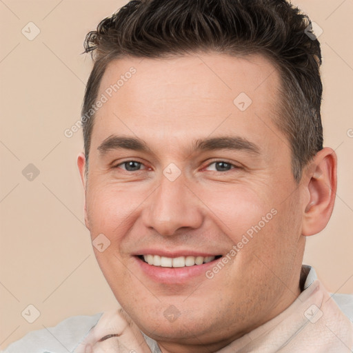 Joyful white young-adult male with short  brown hair and brown eyes